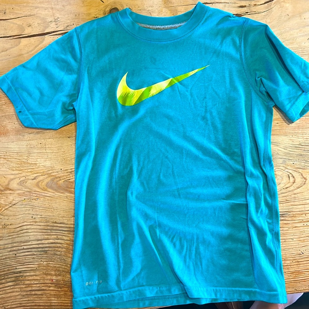 Blue Nike athletic shirt.